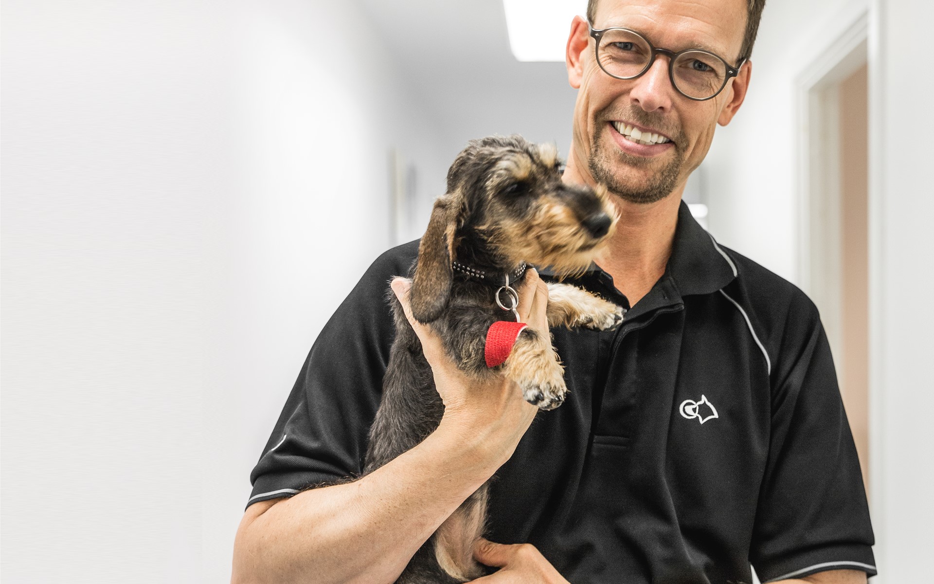 Lekarz weterynarii stomatologicznej Jens Ruhnau trzymający psa